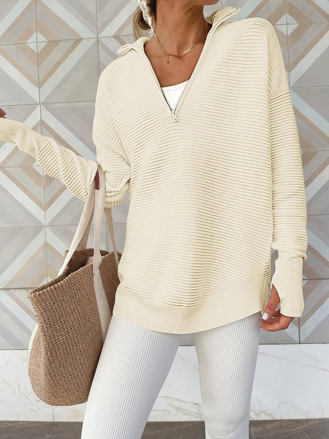 a woman wearing a white sweater and white pants