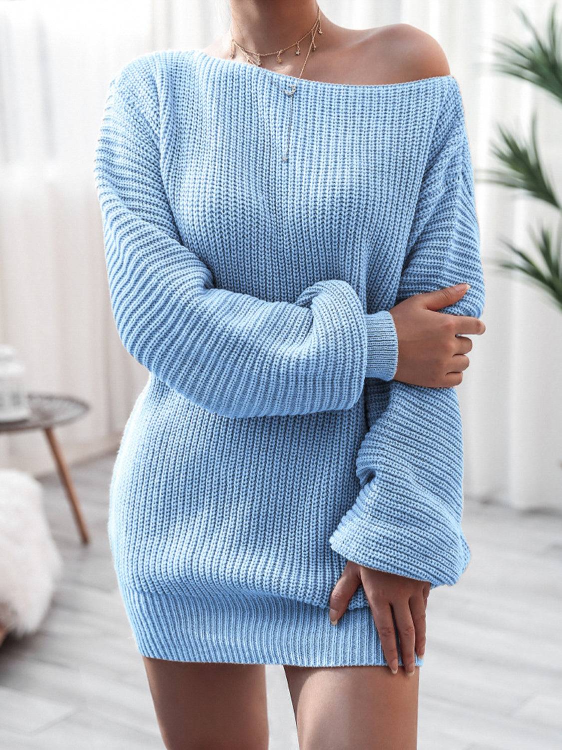 a woman wearing a blue sweater dress