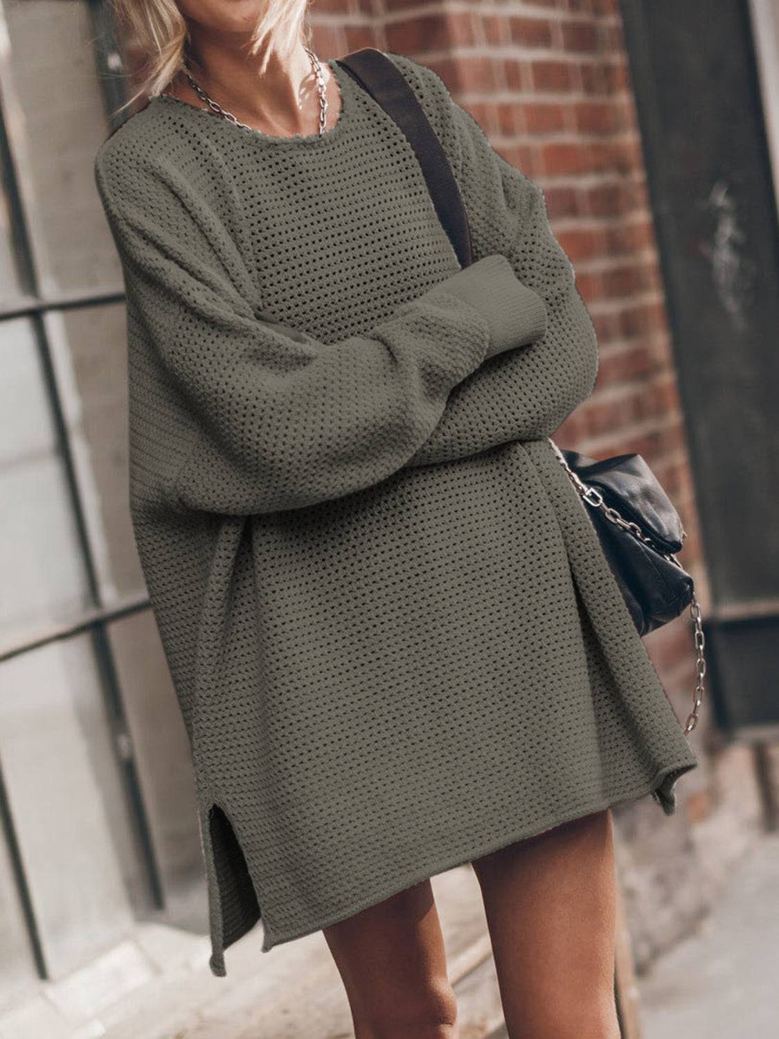 a woman wearing a green sweater and shorts