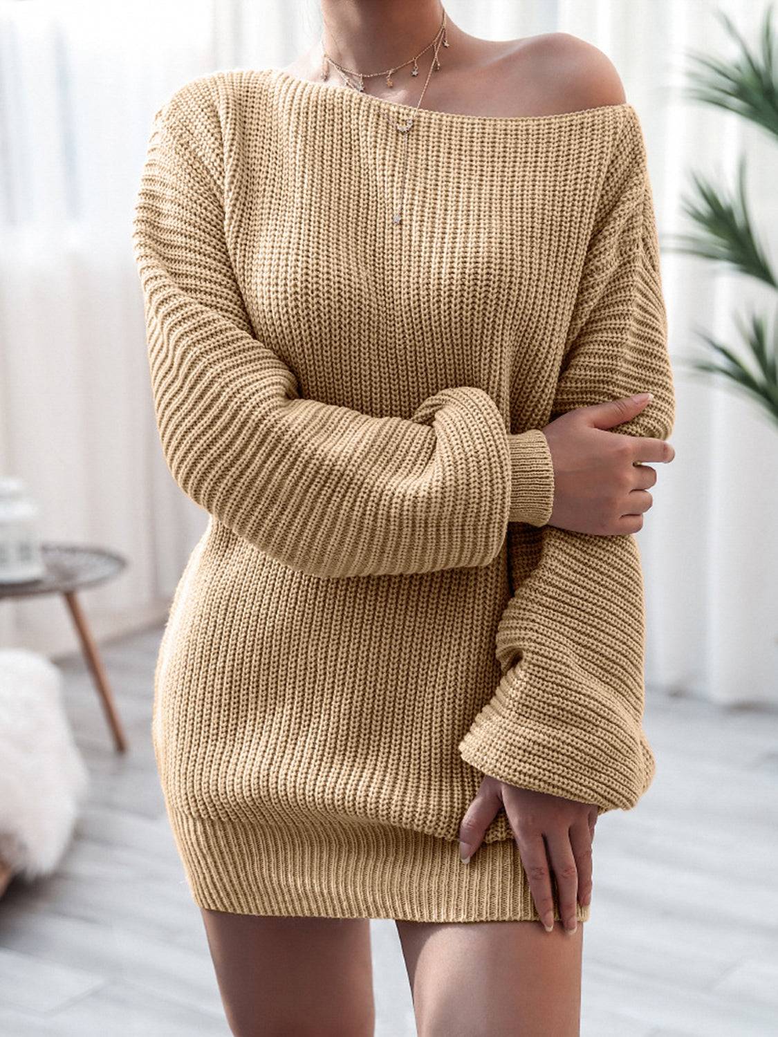 a woman wearing a tan sweater dress