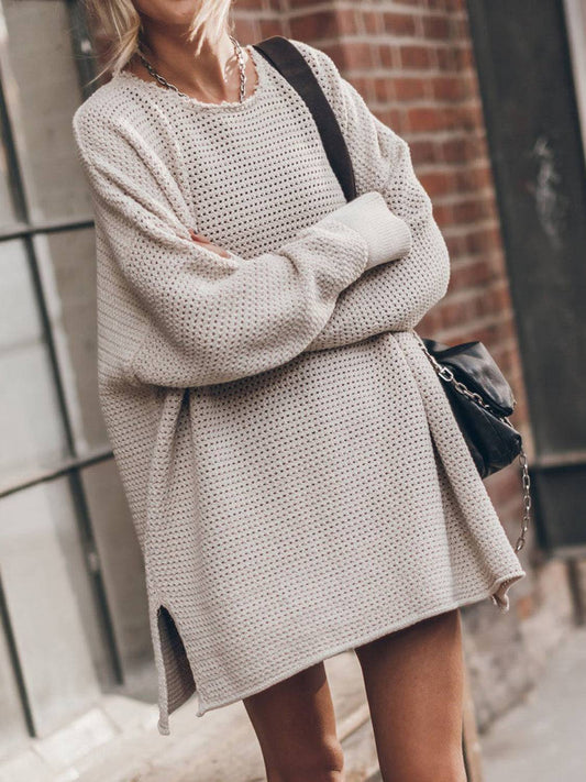 a blonde woman wearing a white sweater and shorts