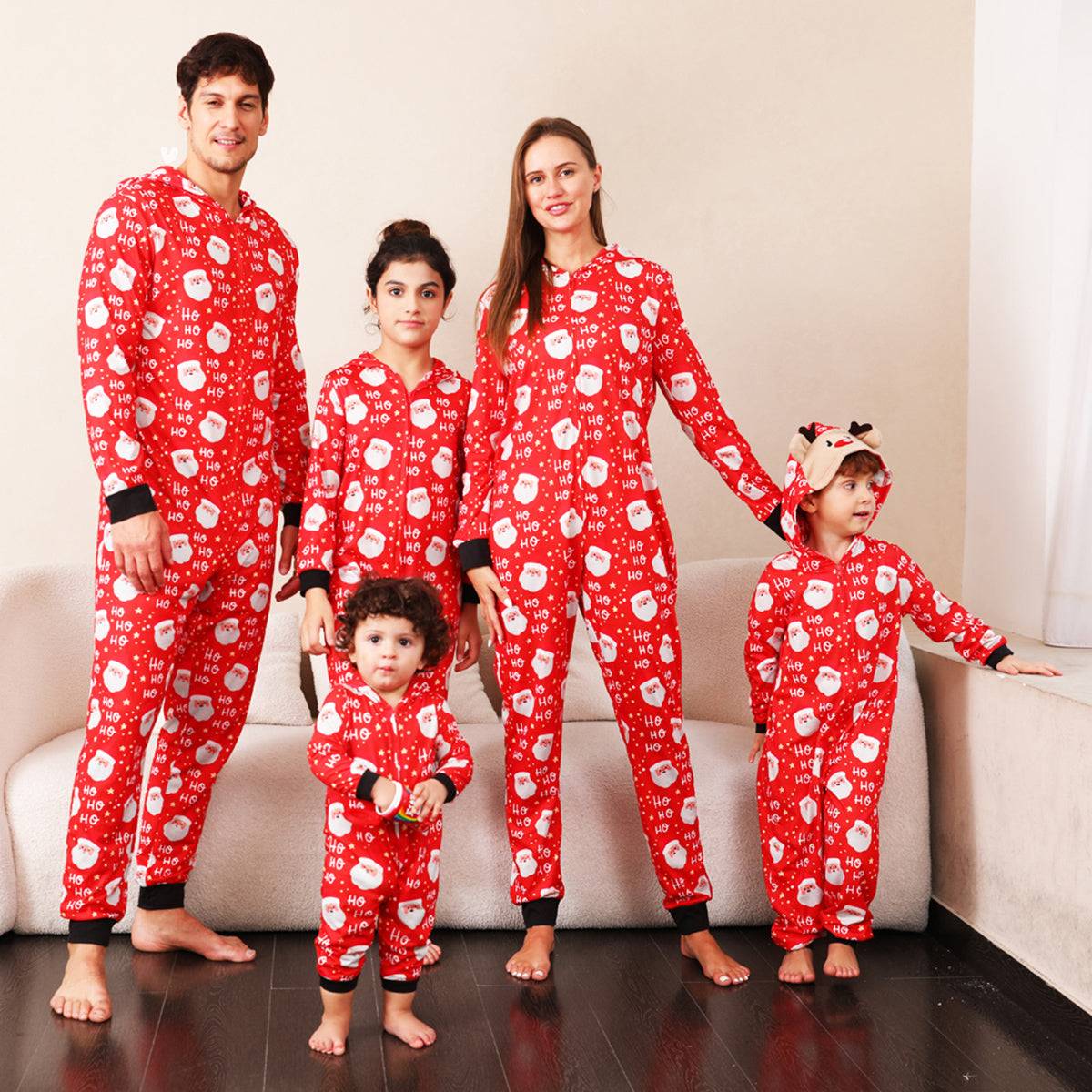 a family of four wearing matching red and white pajamas