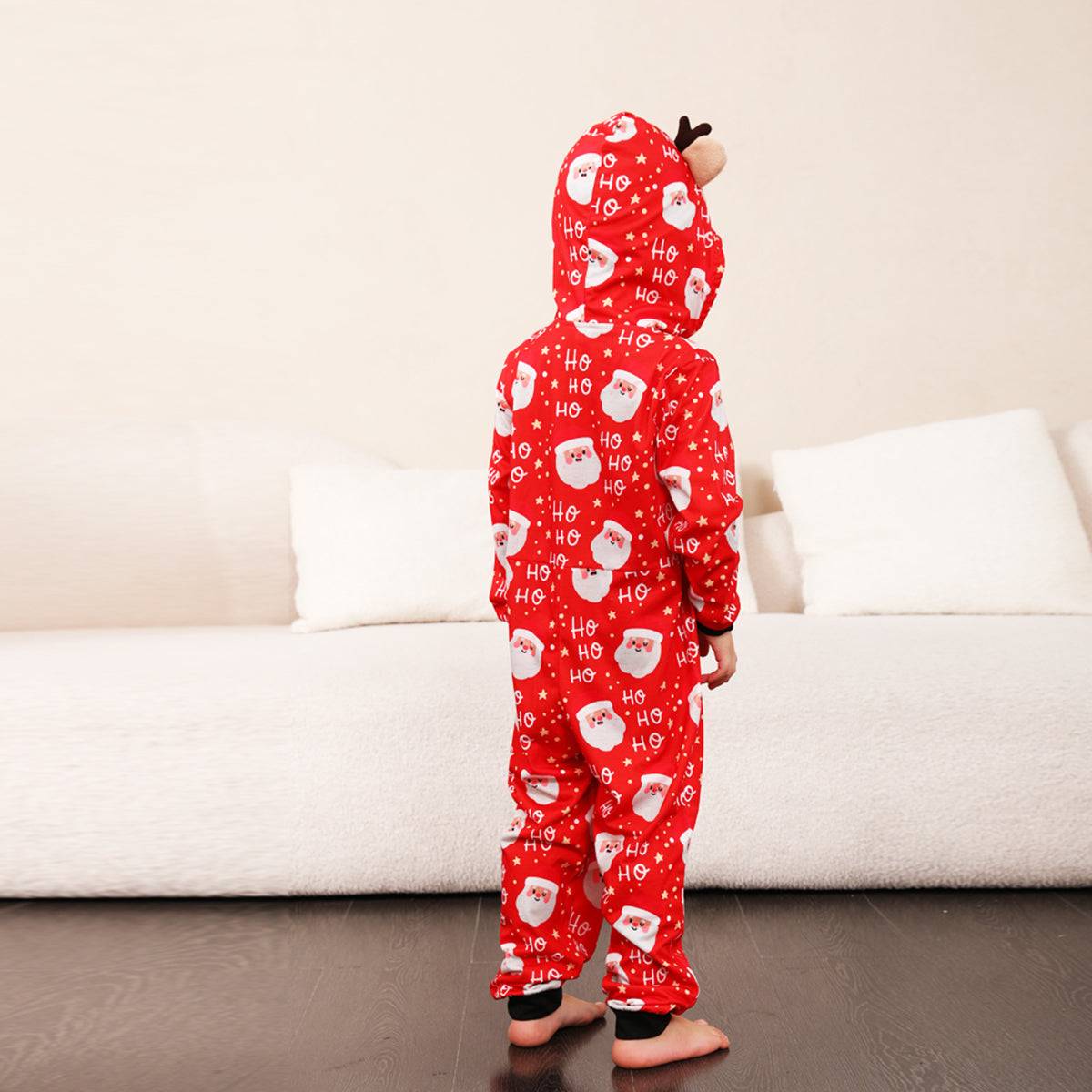 a young child wearing a red hello kitty pajamas