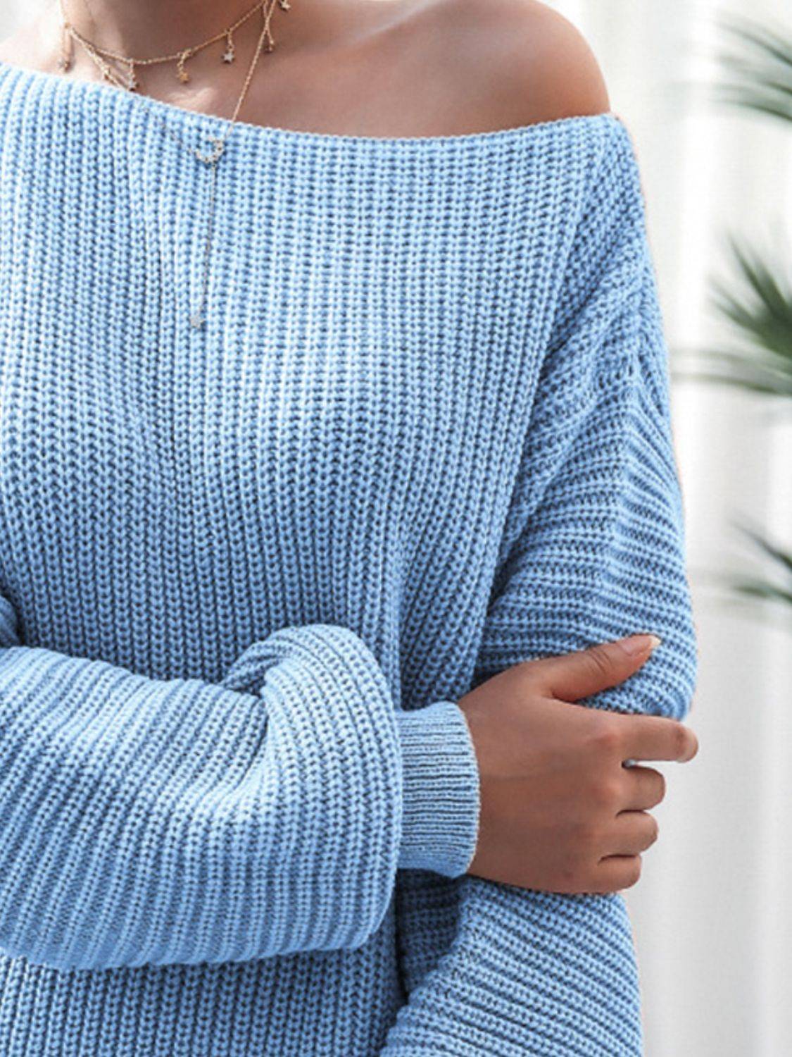 a woman in a blue sweater is posing for a picture