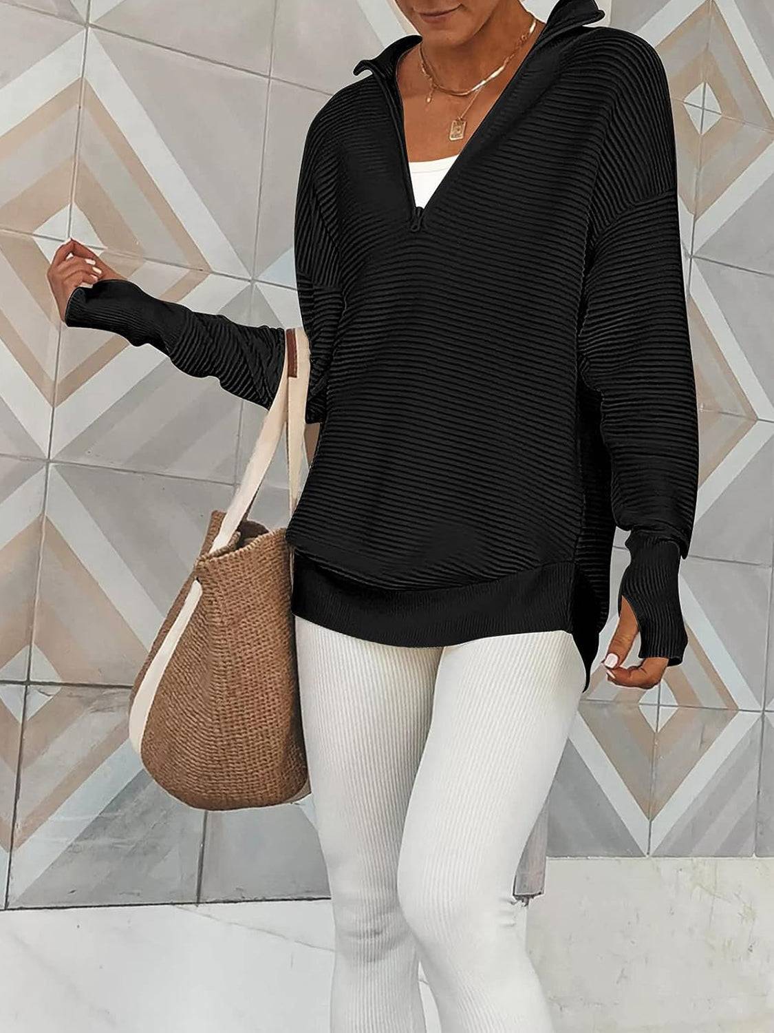 a woman in white pants and a black sweater