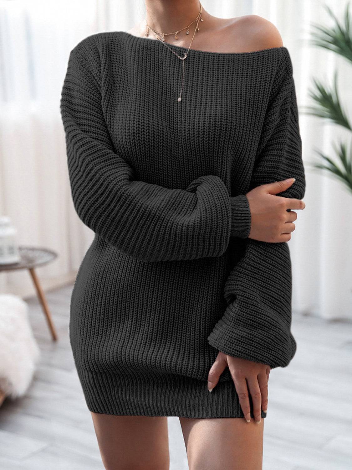 a woman wearing a black sweater dress